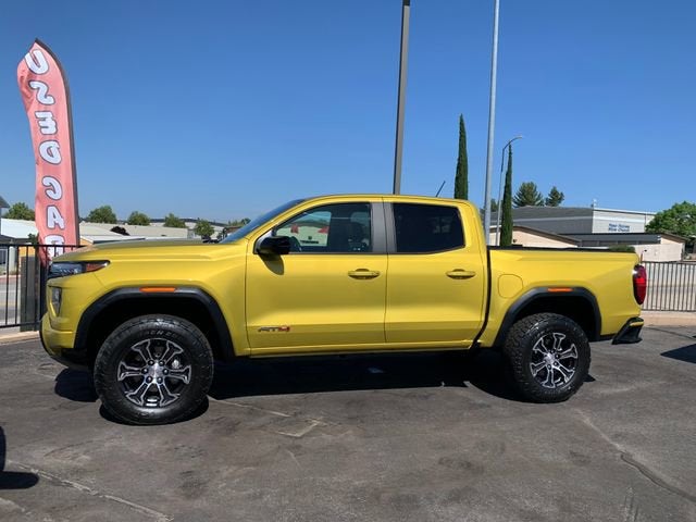 2023 GMC Canyon AT4 in Solar Flare Metallic — front three-quarter view